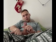 A teen guy with a big circumcised cock comfortably masturbates and cums on the couch at home